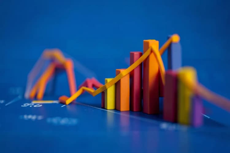 Gráficos de barras e linhas subindo, simbolizando crescimento financeiro, sobre um fundo azul abstrato.
