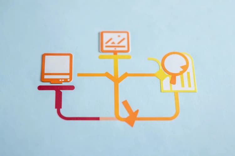 Diagrama de fluxo com setas conectando ícones de computador, lupa e gráfico em fundo azul claro, vista de cima, luz de estúdio, sem ação.